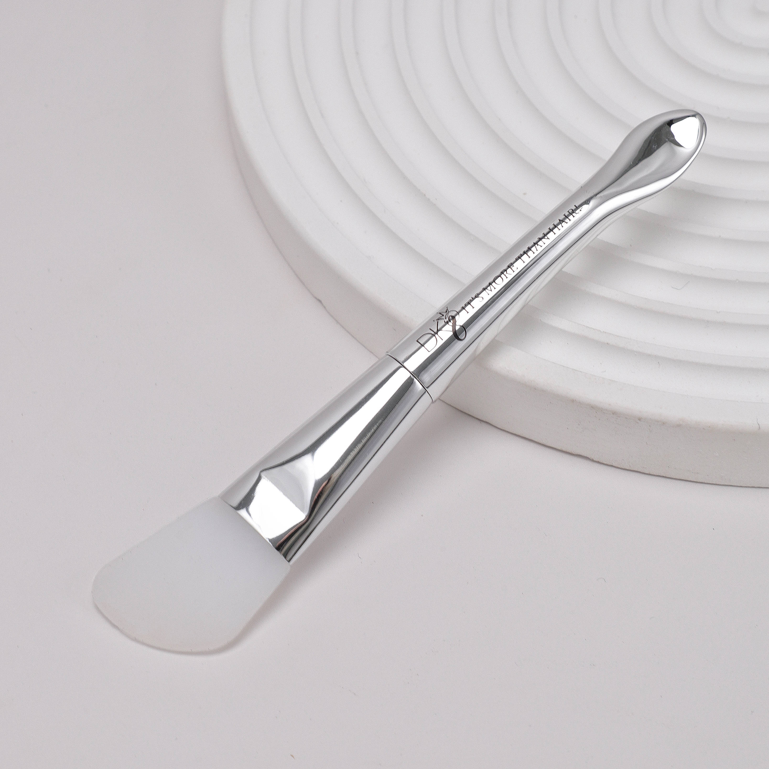 DKEIGHT™ Silicone Angle Brush tilted on side decoration white background - Silicone wig glue applicator